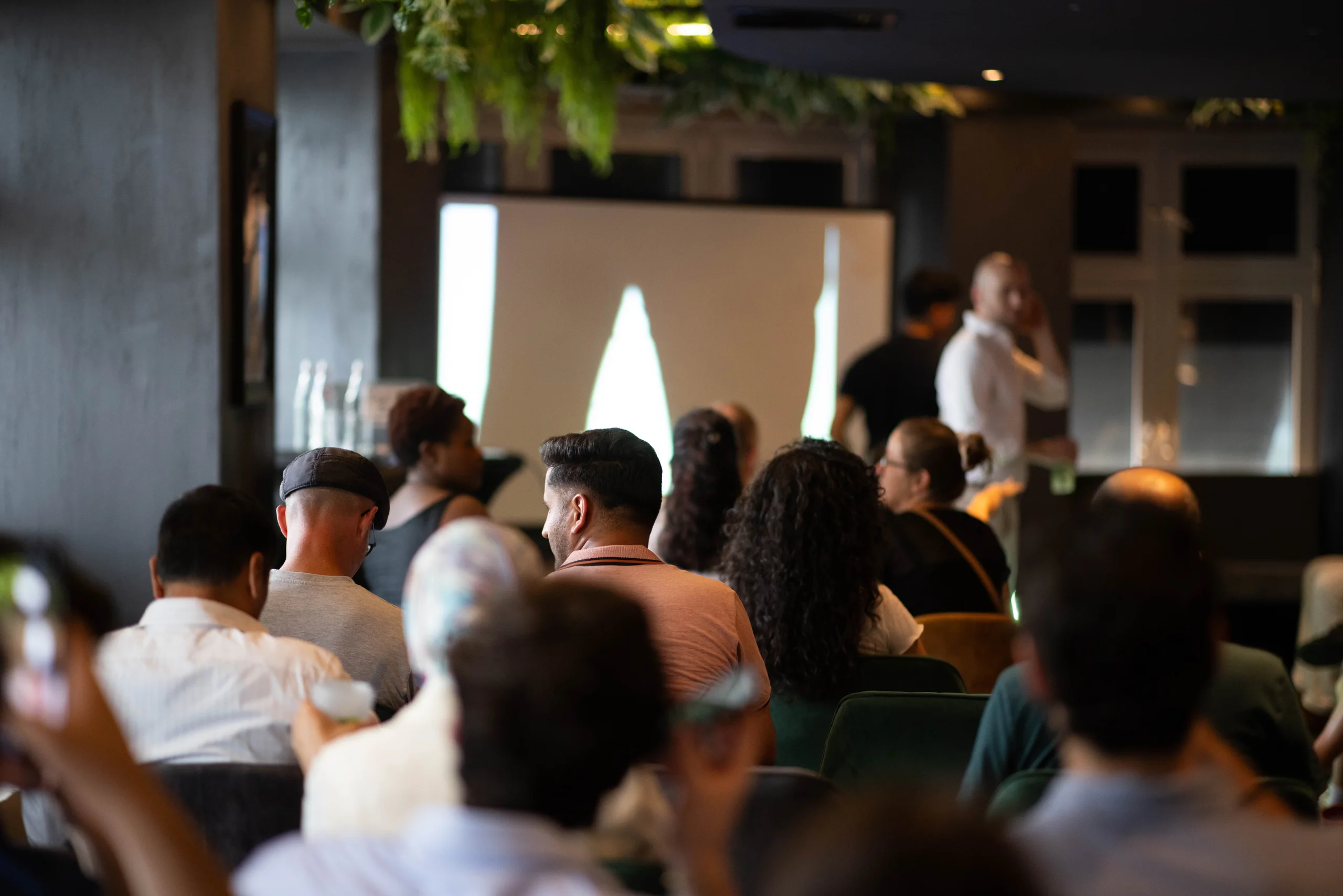 The audience watching a talk at an AI and Coffee All-in event