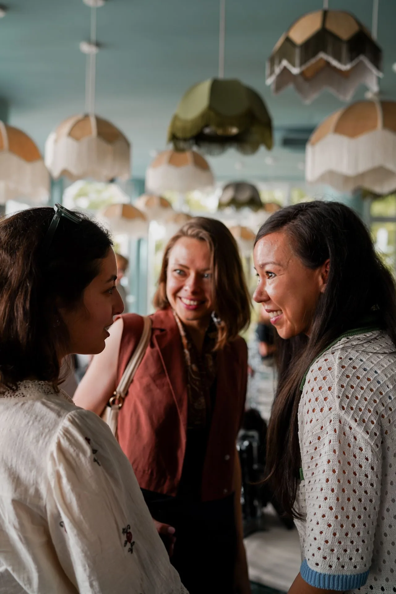 Three members laughing together during the networking part of an event